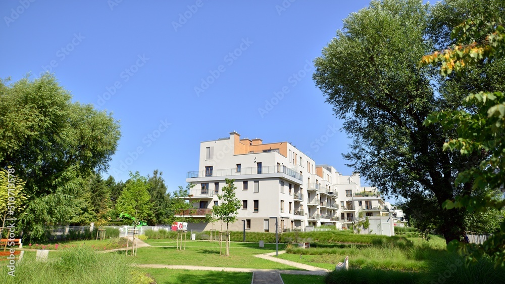 Exterior of new apartment buildings on a blue cloudy sky background. No people. Real estate business