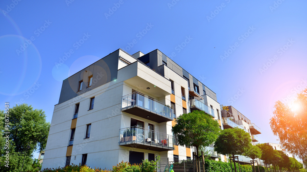 Exterior of new apartment buildings on a blue cloudy sky background. No people. Real estate business