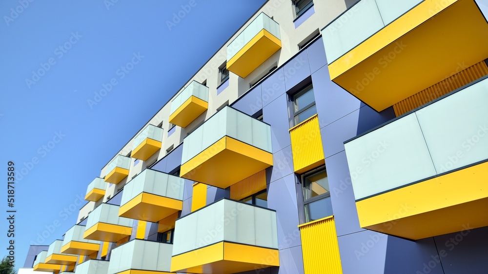 Exterior of new apartment buildings on a blue cloudy sky background. No people. Real estate business