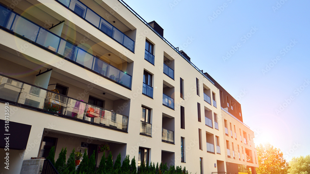 Exterior of new apartment buildings on a blue cloudy sky background. No people. Real estate business