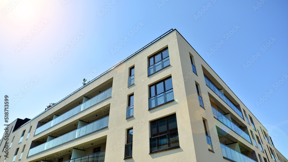 Exterior of new apartment buildings on a blue cloudy sky background. No people. Real estate business