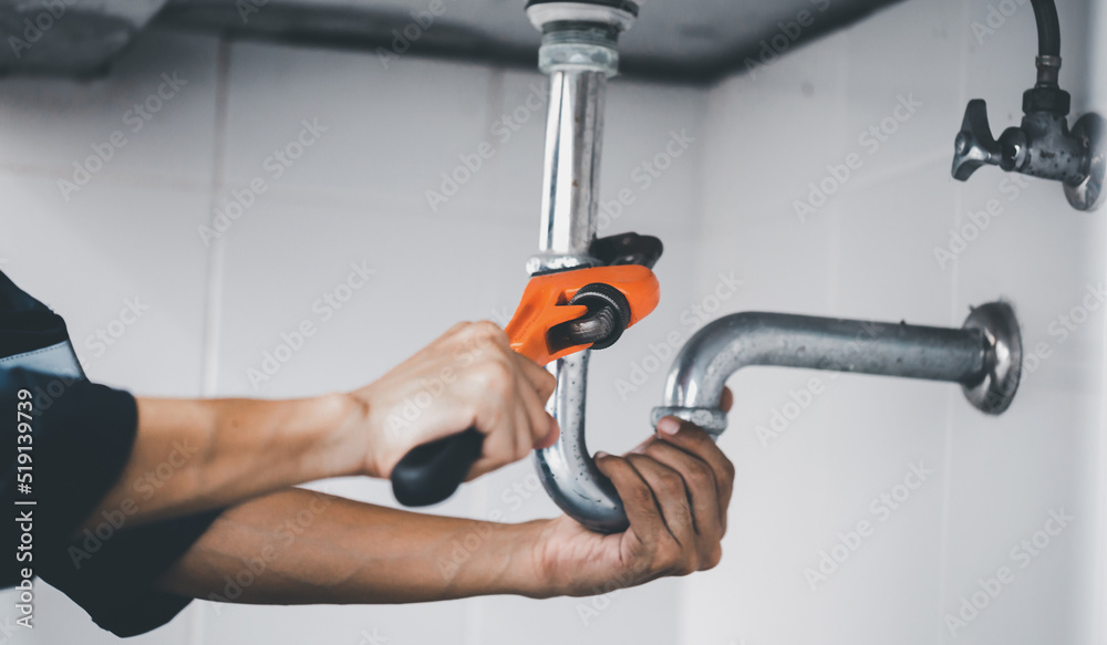 plumber at work in a bathroom, plumbing repair service, assemble