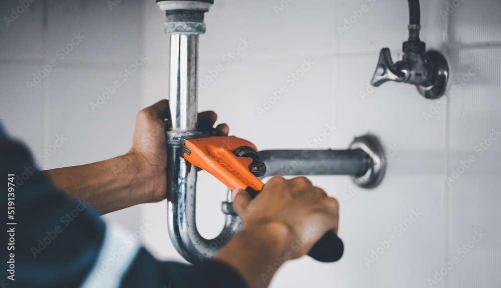 plumber at work in a bathroom, plumbing repair service, assemble