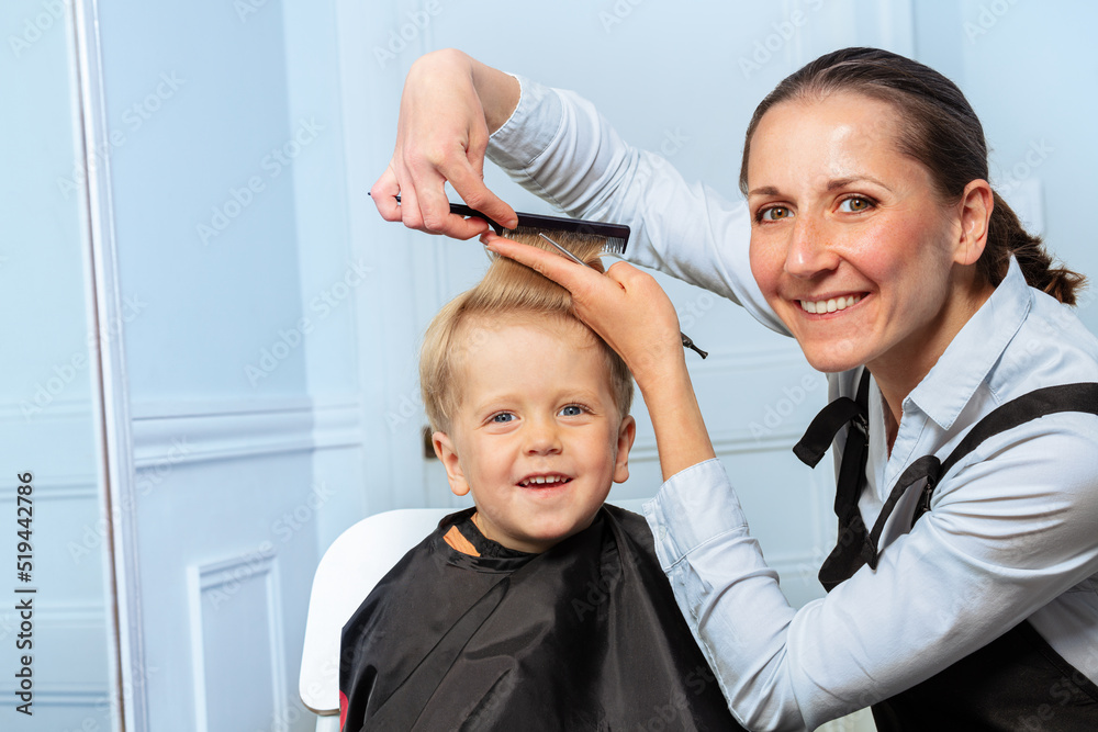 Hairdresser woman discuss how to cut forelock of the little boy