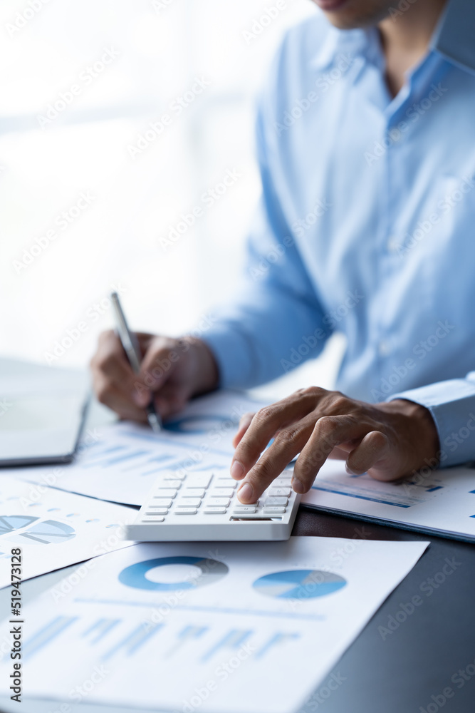 businessman working in office with using calculator and laptop. concept finance and accounting