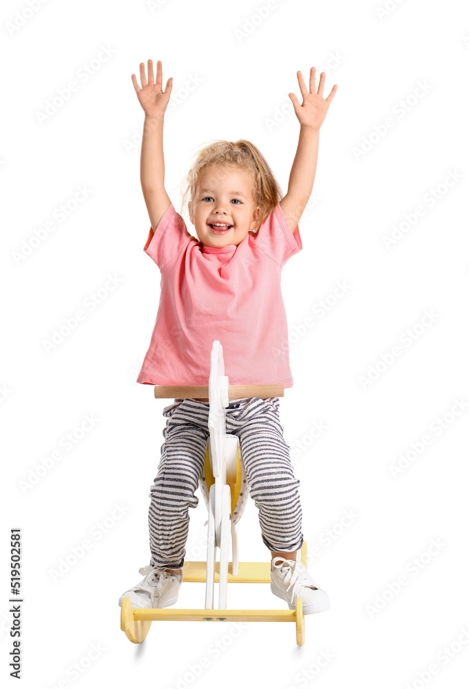 Cute little girl with rocking horse on white background