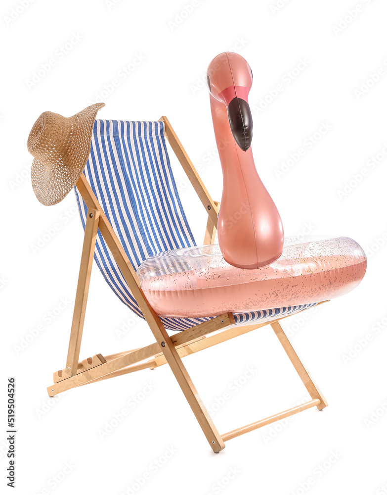 Deck chair with hat and inflatable ring on white background