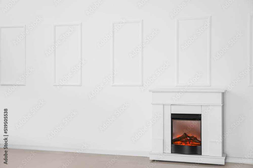 Modern fireplace near light wall