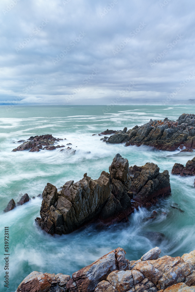 The beautiful coastline at De Kelders with a view across Walker Bay towards Hermanus, Overberg, West