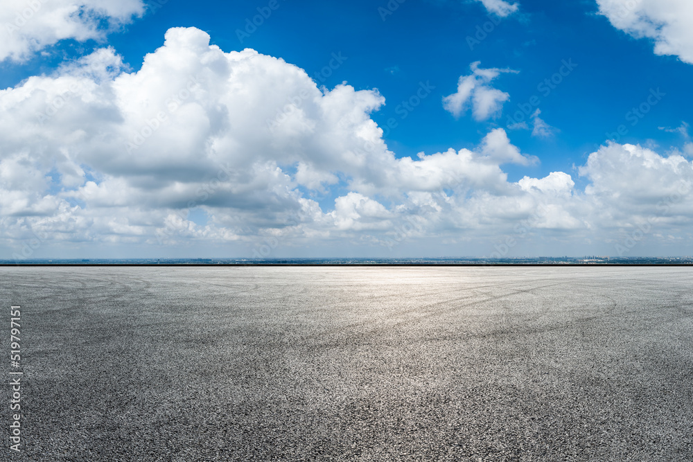 Empty asphalt road and city skyline with sky cloud scenery