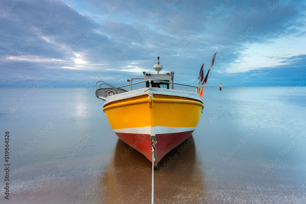 Beautiful sunset with fishing boats at the beach of Baltic Sea in Sopot, Poland