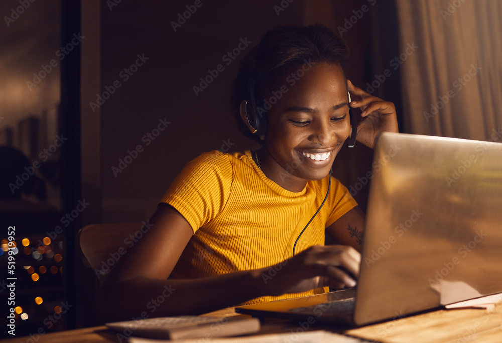 Young, happy and beautiful woman working while listening to music. Girl making work fun and joyful t