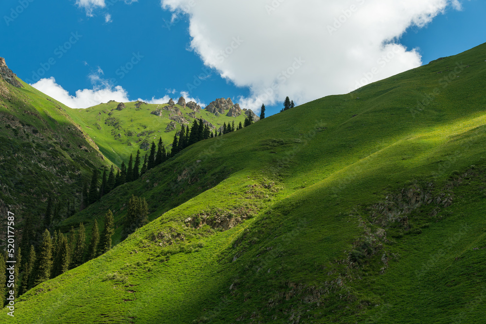 clouds shadow on green mountains