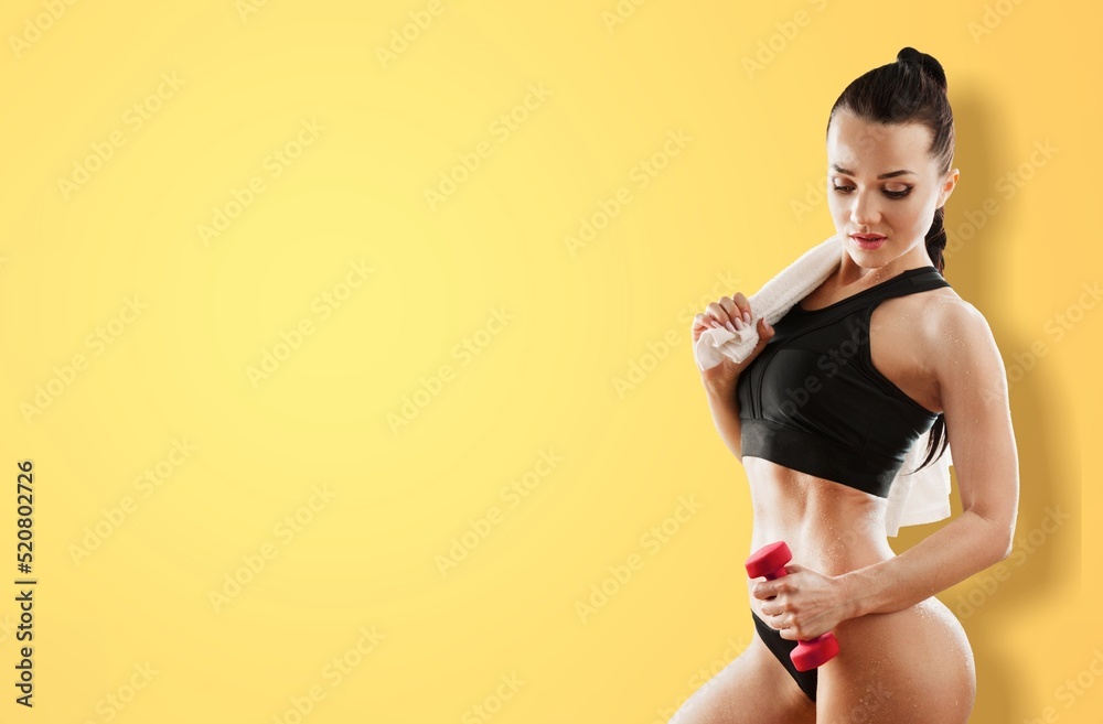 Portrait of happy young woman in sports outfit posing and smiling, being in great shape, leading act