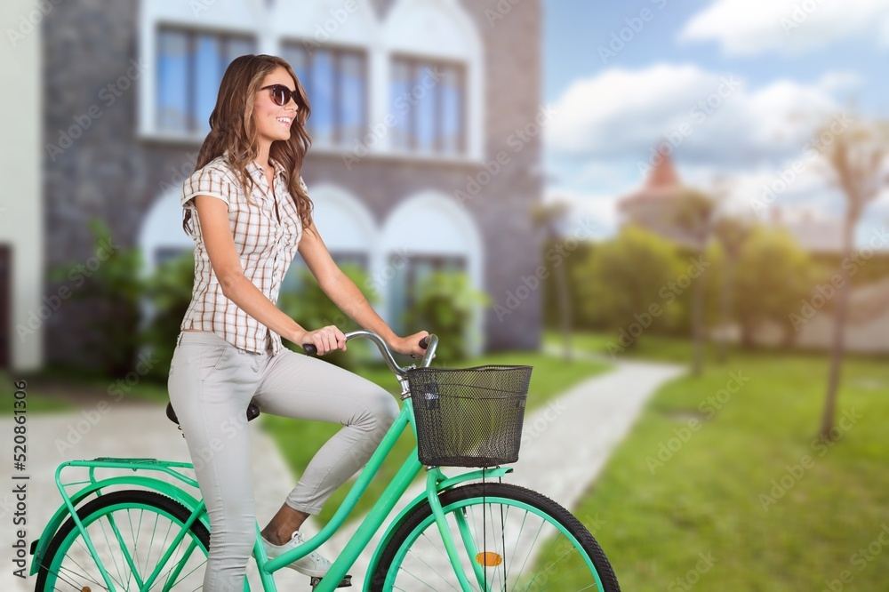 nice active woman riding her mountain bike in the green city