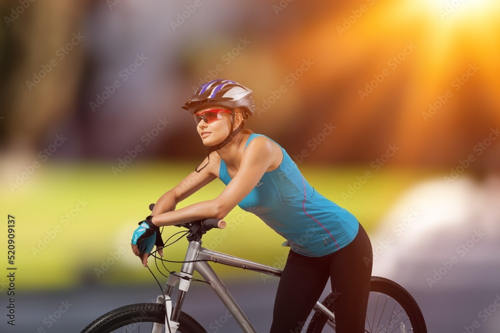 Cyclist Woman riding bike in helmets go in sports outdoors on sunny day. Fresh air. Health care, aut