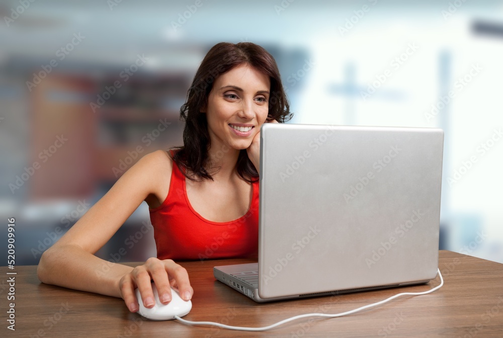 Beautiful portrait of young woman and student worker working on her computer or laptop at the office