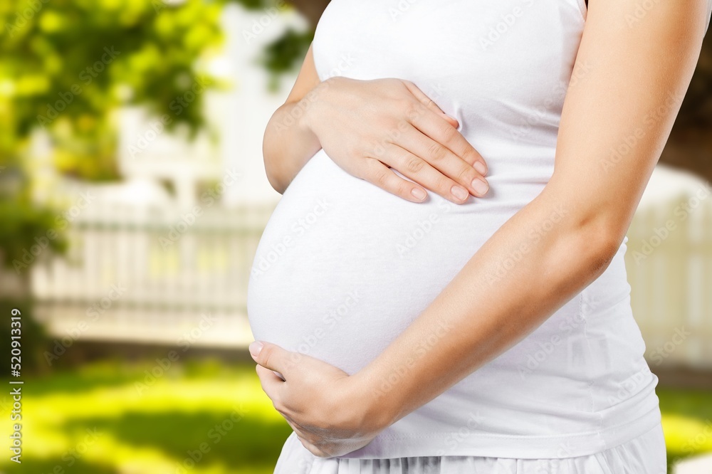 Pregnant woman during spring nature walk. Happy pregnancy outdoors active lifestyle