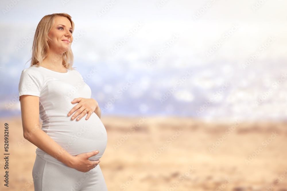 Pregnant woman during spring nature walk. Happy pregnancy outdoors active lifestyle