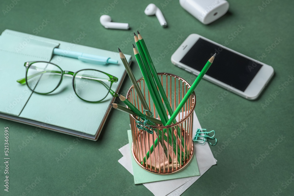 Holder with ordinary pencils on table