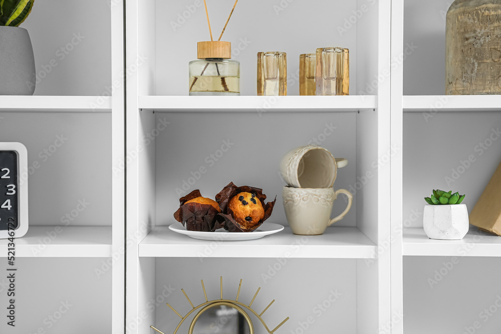 Big shelving unit with food and decor in room