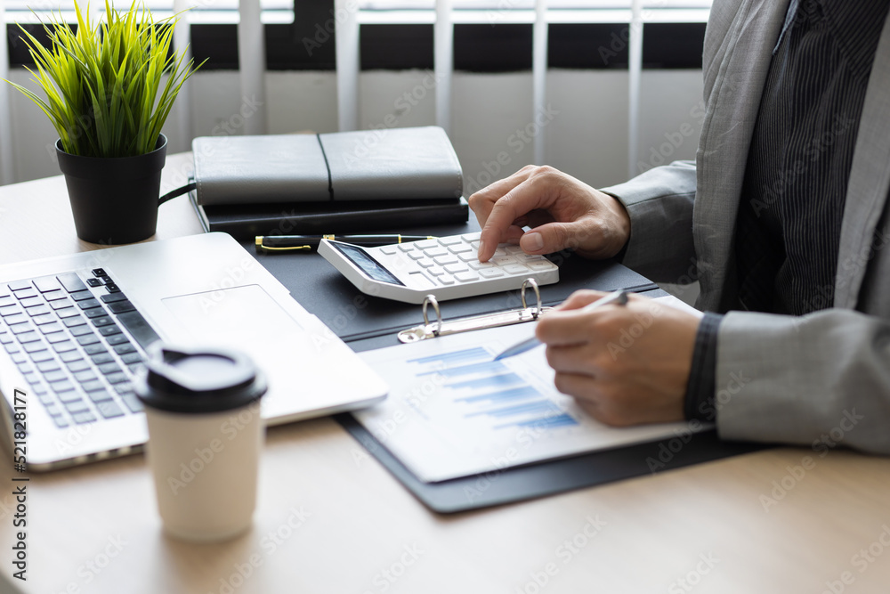 Businessman working about financial with calculator at office to calculate expenses. Accountant calc