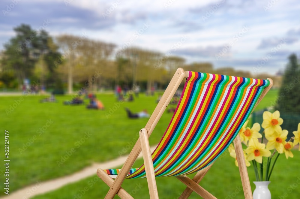 A garden chair. Summer vacation in green surroundings. Happy outdoors relaxing. Outdoor leisure