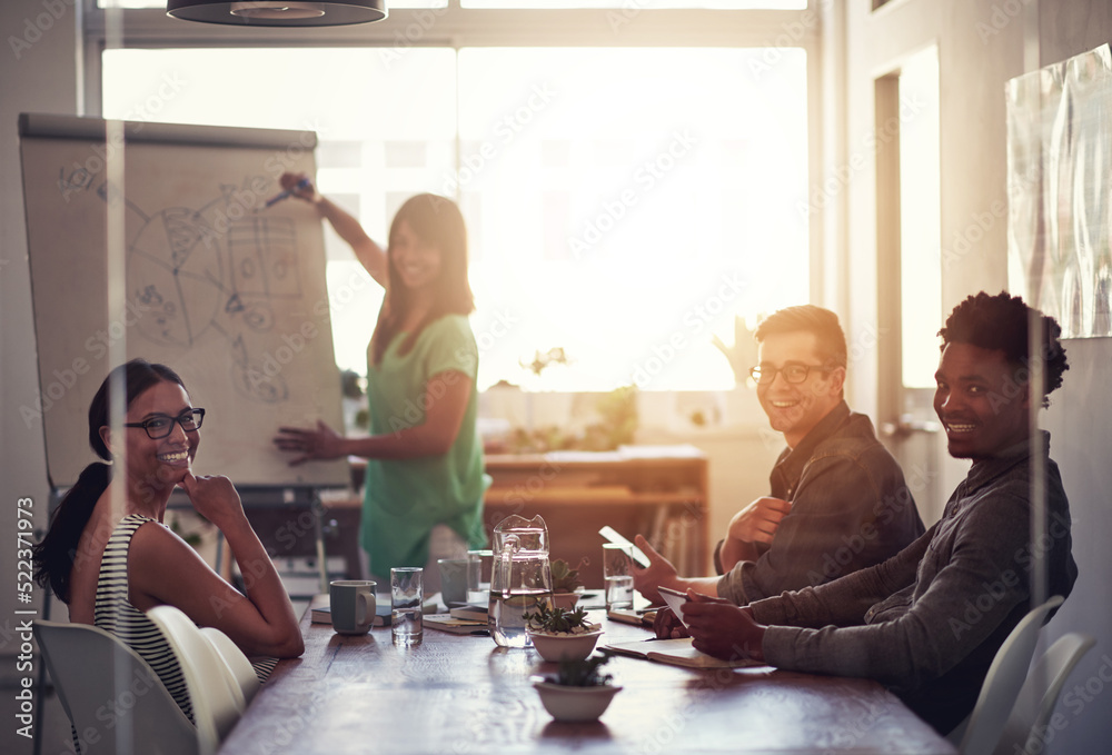 Happy business woman leader writing on board explaining ideas and thoughts while brainstorming with 