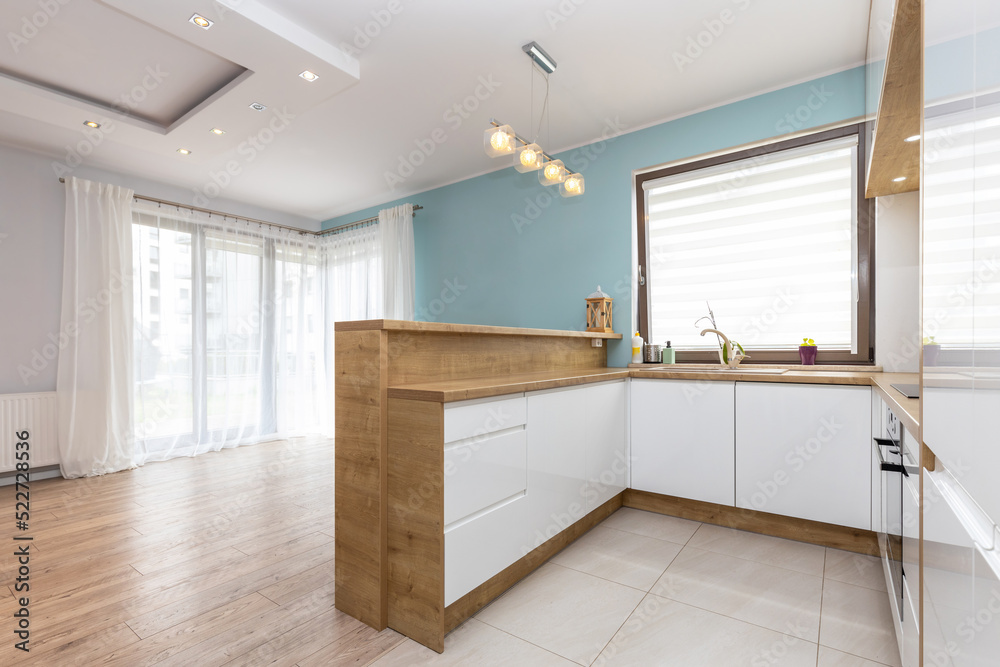 Modern white kitchen interior with wooden worktops