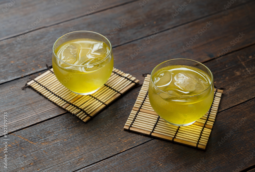 Cold Japanese green tea placed against a wooden background.