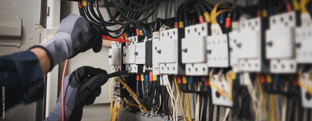 Electricity and electrical maintenance service, Engineer hand holding AC multimeter checking electri