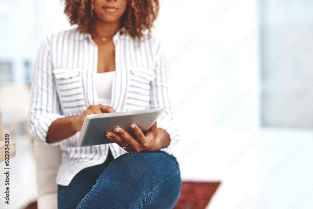 Female holding a tablet, scrolling the web online and social media at home. Casual woman checking em