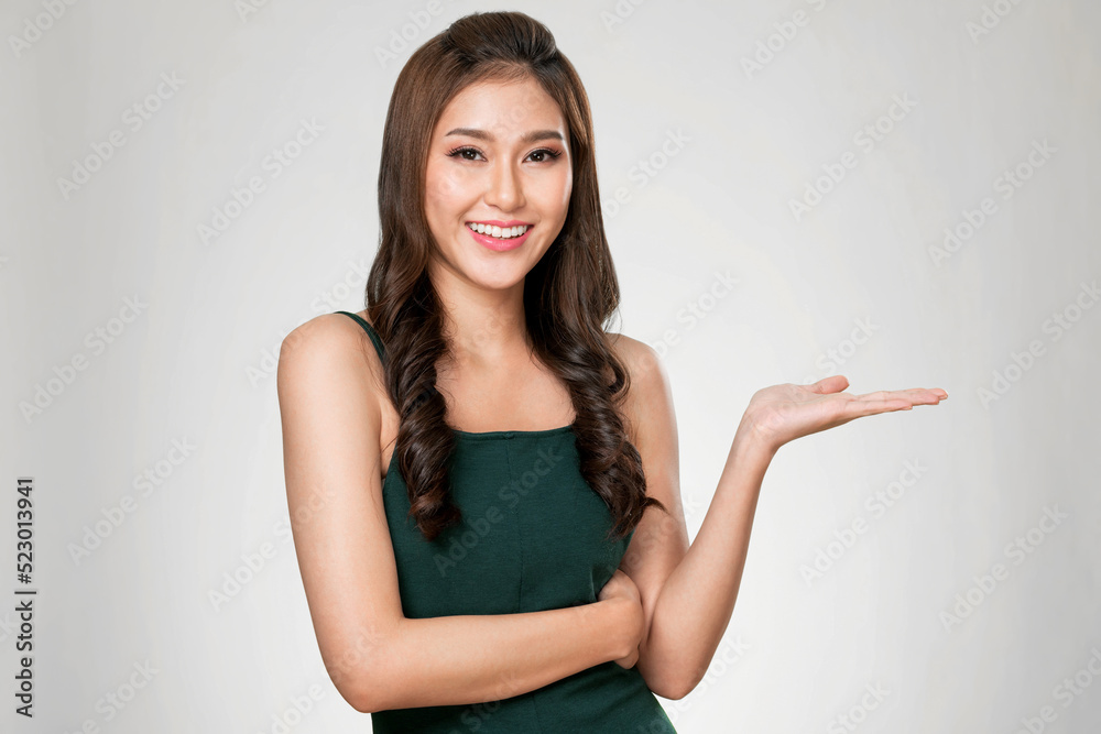 Portrait of ardent woman looking at camera, holding empty space for product, advertising text place,