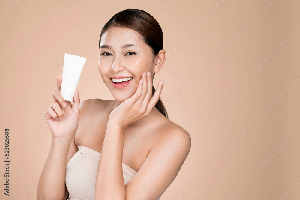 Ardent woman smiling holding mockup product for advertising text place, light grey background. Conce