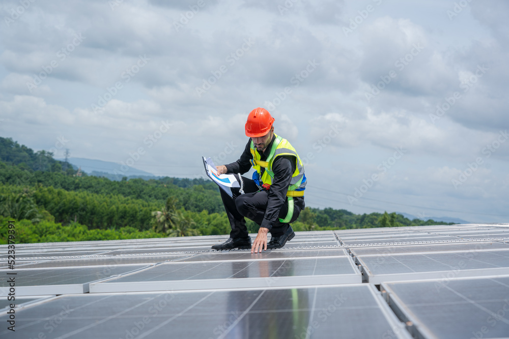 Engineers checking solar panel on the roof of factory.