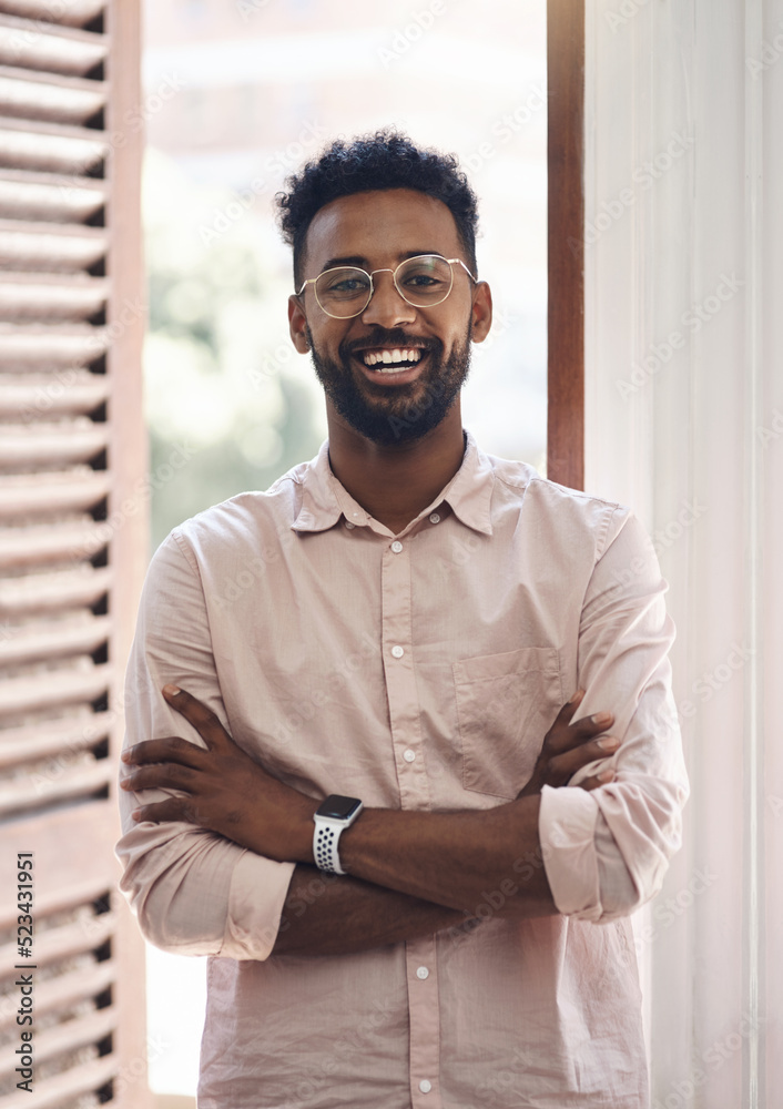 Happy, carefree and positive young business man standing arms crossed in his office at work. Portrai