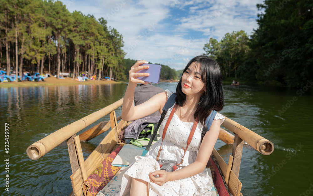 Asian traveller girl selfie on the bamboo boat at pangung