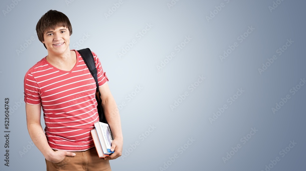 Happy school, college or university student with backpack. Cheerful handsome young man smiling