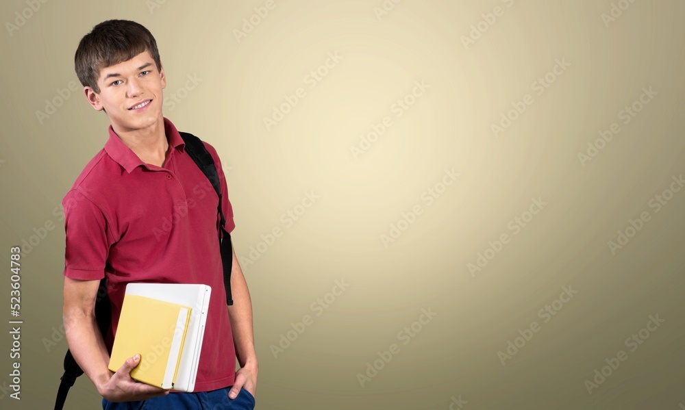 Happy school, college or university student with backpack. Cheerful handsome young man smiling