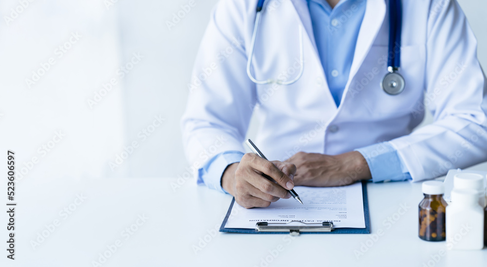 Online medical consultation doctor working on laptop computer in clinic office, healthcare, medical 