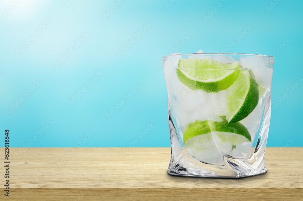 Summer refreshing lemonade drink or alcoholic cocktail with ice and lemon slices. Fresh healthy cold