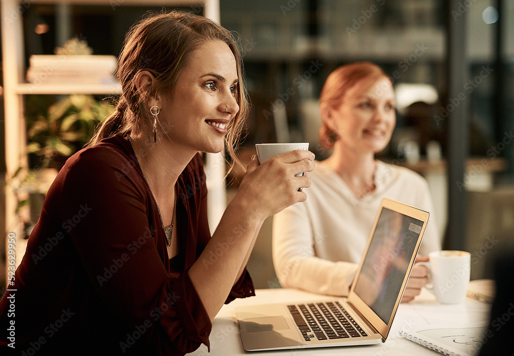 Young, happy and smiling female students enjoying a cup of coffee in a cafe or restaurant while work