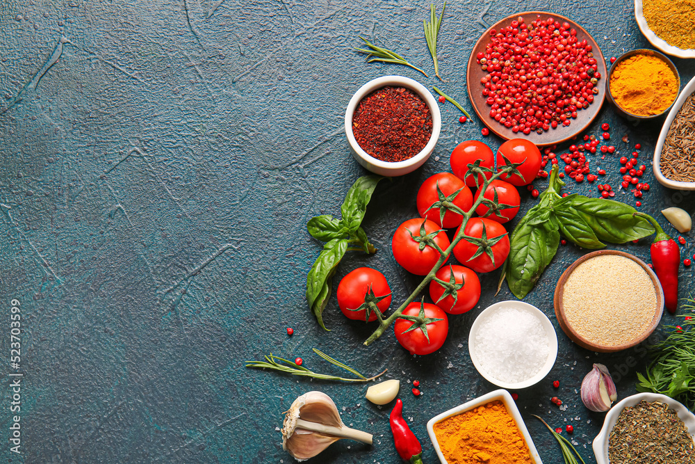 Composition with aromatic spices and tomatoes on color background