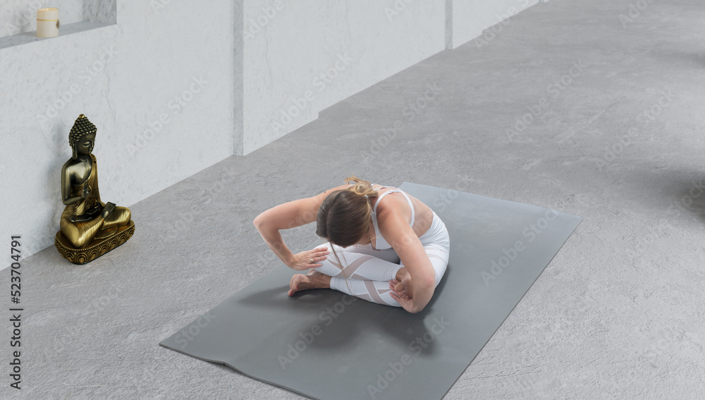 Young athletic attractive woman practicing yoga.