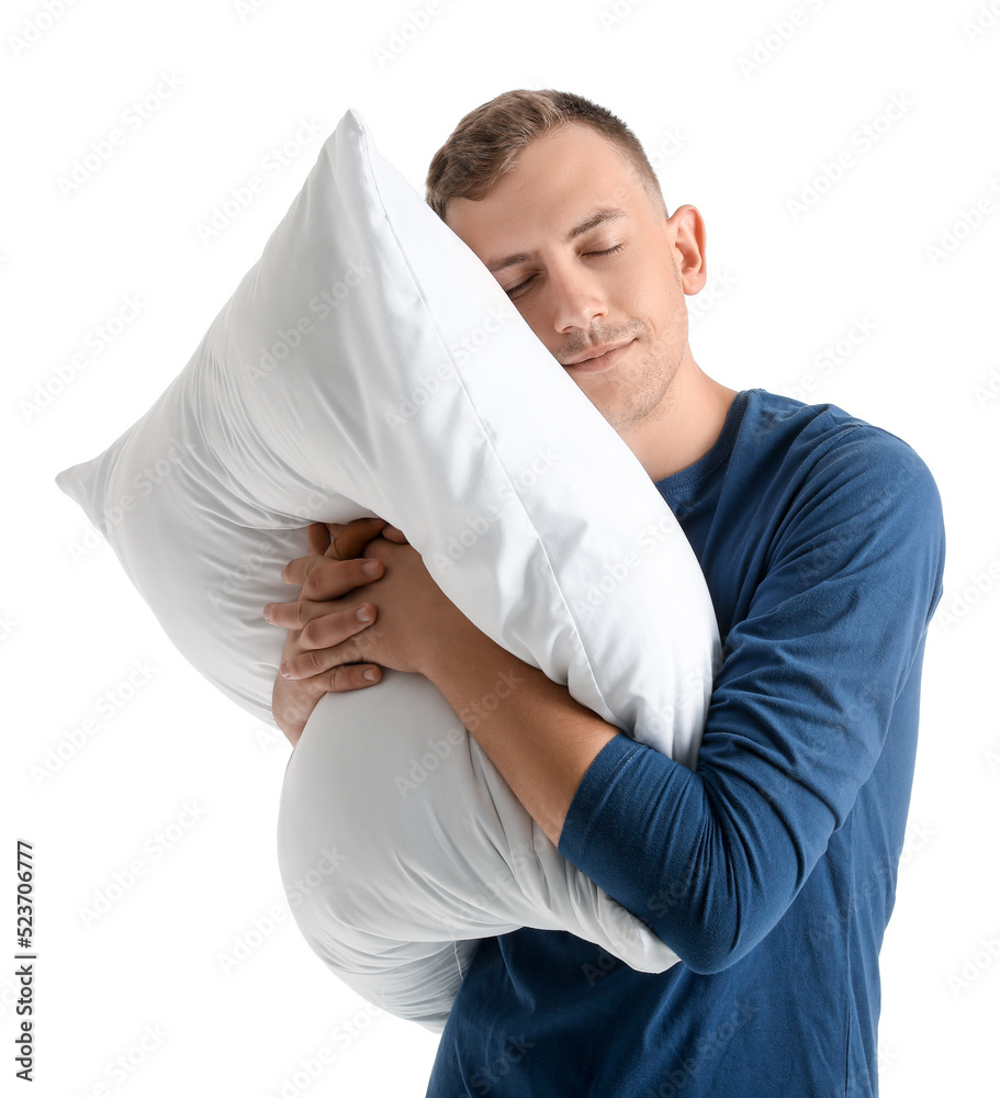 Young man with soft pillow on white background