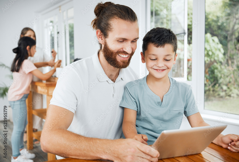 Learning with tablet, watching educational videos and searching the internet with father and son rel