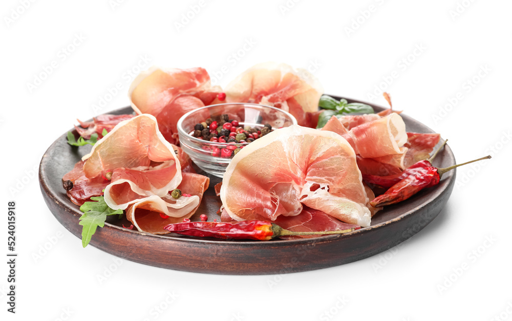 Wooden plate with delicious jamon and spices on white background