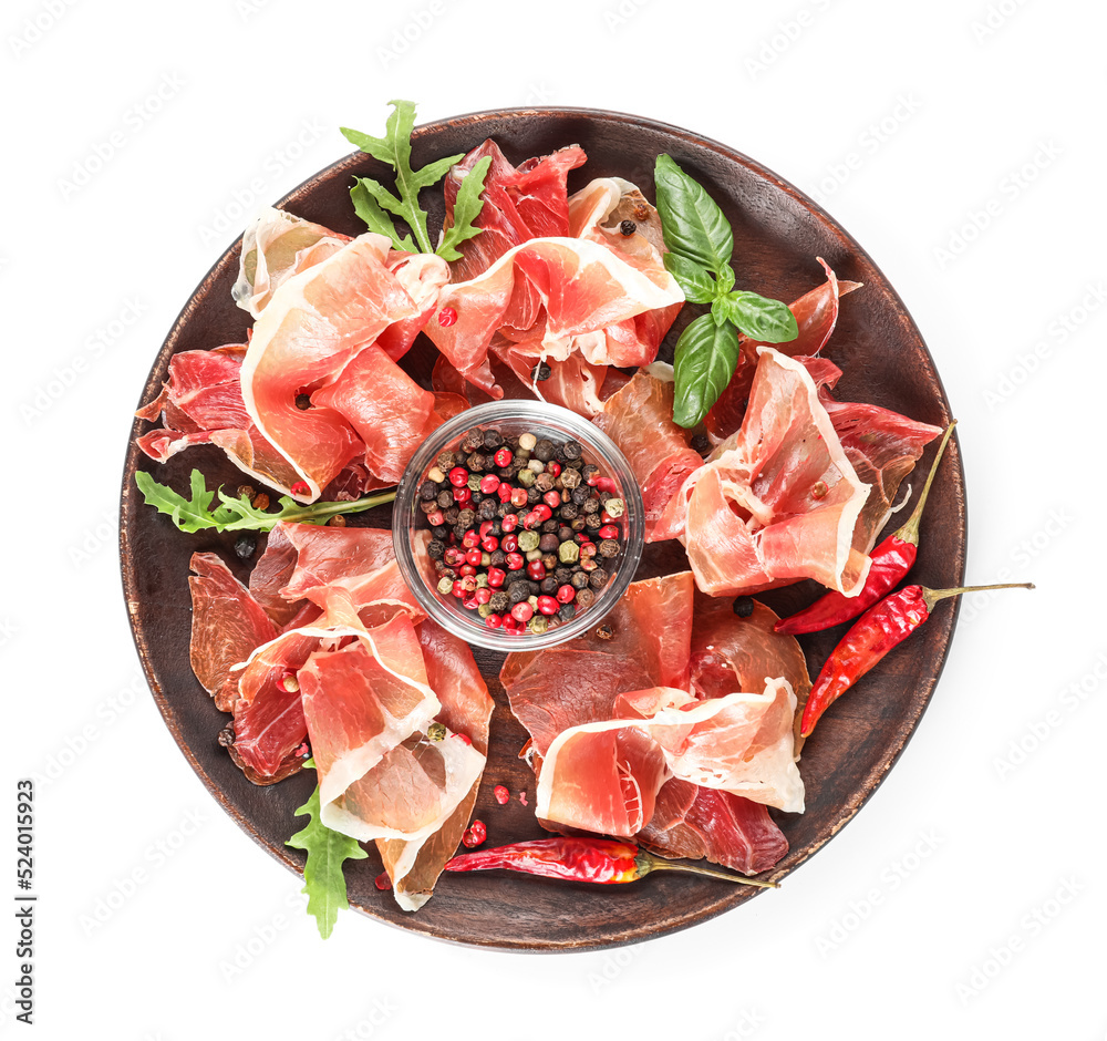 Wooden plate with delicious jamon and spices on white background