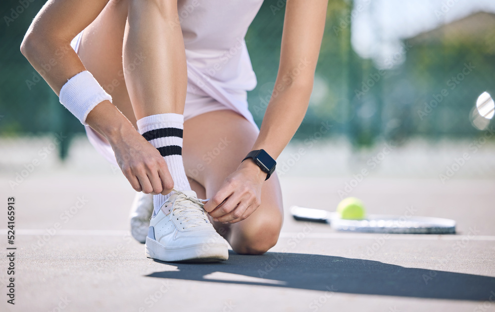 Female tennis player foot and hands tying shoelaces before game match on outdoor sports court. Activ