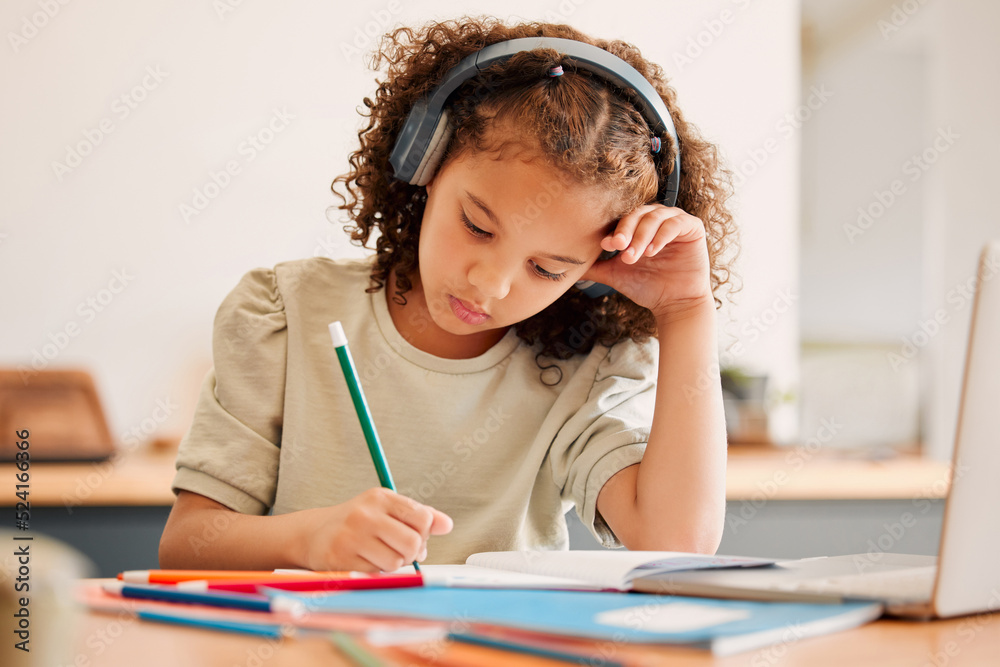 Smart school child, student virtual learning while writing in her book inside an education classroom